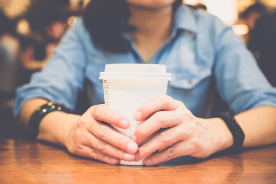 Close Up Woman Hand Holding Paper Coffee Cup On Table In Cafe Shop,leisure Activity