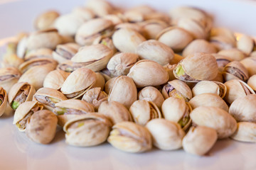 Delicious pistachios on a white plate