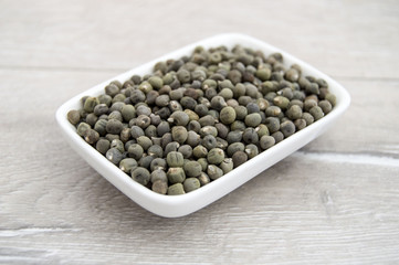 Ready to plant very clearly with white back ground okra seeds, okra seeds in the plate,
