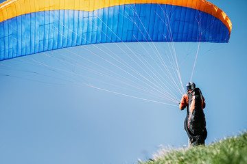 Paraglider prepear to start flying
