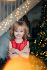 portrait of cute girl for Christmas at the Christmas tree	