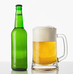 Glass of beer with bottle