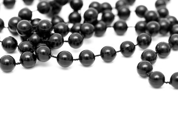 Black beads on a white background