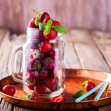 Fresh Strawberries in a glass Jar for Drinks on Vintage wooden background.Food or Healthy diet concept.Vegetarian.Copy space for text. selective focus