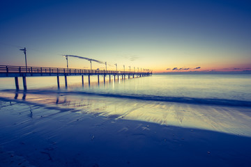Wooden pier in Mechelinki. Small fishing village in Poland. Amazing Sunrise at the beach