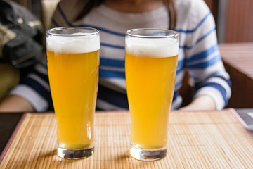 Two glasses of beer on a table in restaurant