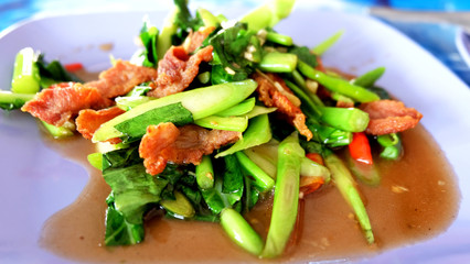 Close up stir-fried kale with crispy pork and oyster sauce,Thai cuisine.