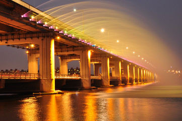 Rainbow Fountain Bridge at night with yellow lights