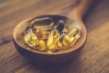 Fish oil capsules with omega 3 and vitamin D. Healthy diet concept