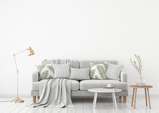 Fototapeta Neutral livingroom interior with fabric sofa, pillows, plaid, lamp and green plant on white wall background. 3d rendering.