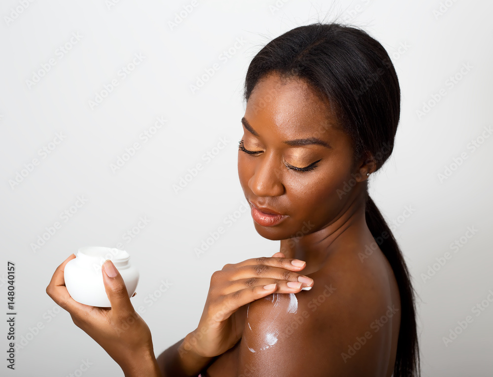 Wall mural african american beauty applying skin cream