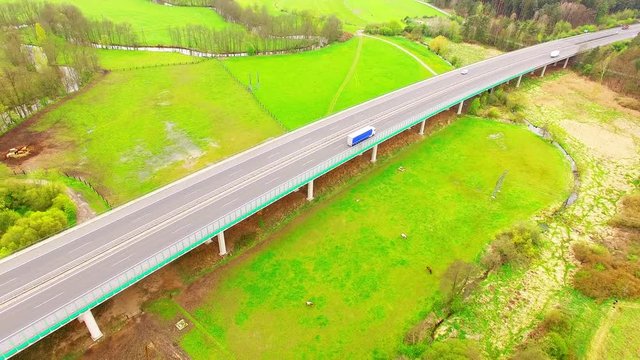Aerial view of bridge over Radbuza River and green pastures. Highway D5 with traffic near Pilsen, Czech republic, Central Europe. Transportation and sustainable development concept. 