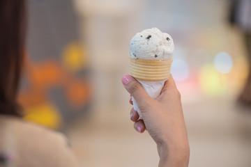 Asian woman holding ice  cream cone