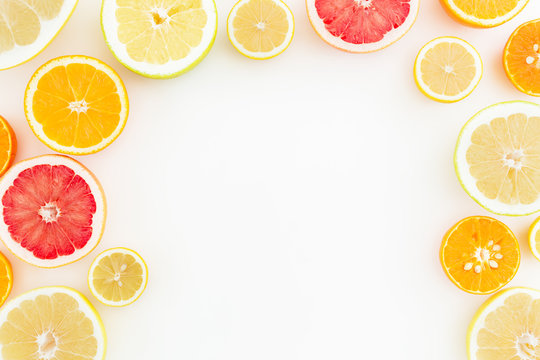 Fruit background. Sliced of citrus fruits on white background. Flat lay, top view.