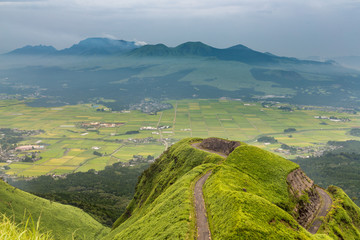 Aso volcano mountain and farmer village from hill top in Kumamoto, Japan