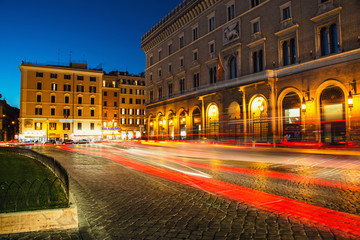 Fototapeta na wymiar Venezia Palace /Palazzo Venezia/ - the palace of Victor Emmanuel at the Venezia Square /Piazza Venezia/ in Rome, Italy at night. Long exposure, car lights trails effect.