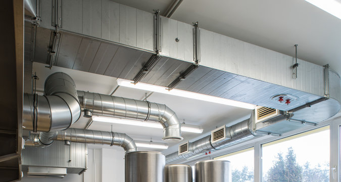 Ventilation pipe system in kitchen interior.