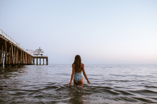 girl walking slowly in the sea