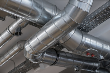 Ventilation pipe system in kitchen interior.