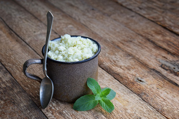 Milk ice cream from green tea in a metal mug on a wooden background. Mint Sorbet. Place for text