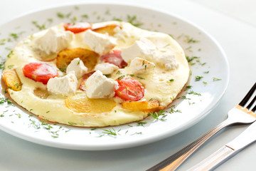 Tasty omelette with tomato, cheese and potato