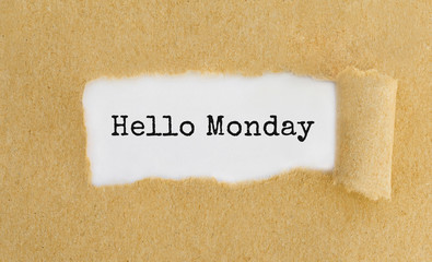 Text Hello Monday appearing behind ripped brown paper