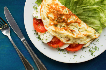Folded omelette with tomato and mozzarella cheese