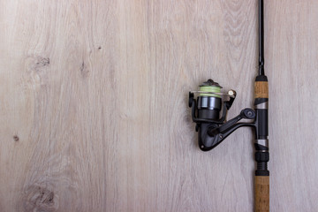 Spinning for fishing  on a wooden background