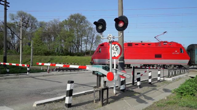 Railroad crossing with train passing by