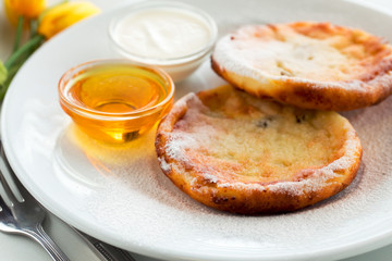 Cottage cheese fritters with honey ukrainian cuisine