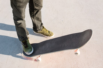 Fototapeta na wymiar Close-up of skateboarders foot while skating in skate park