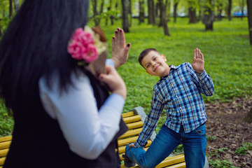 Mom and son are playing in the park. Family photo session.