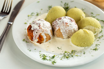 Roasted pork meatballs with cream sauce and potatoes