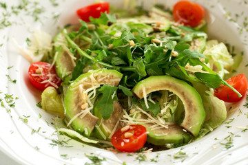Tasty salad with avocado and arugula