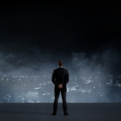 Obraz premium Businessman standing over night city background. Job, business, career, concept.