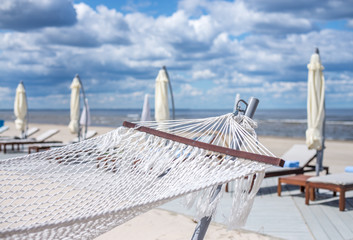 Travel concept with a hammock in a tropical beach with turquoise water in the background