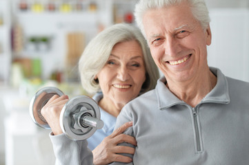 Beautiful elderly couple in a gym 