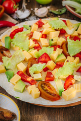 Tortilla with salad over it, surrounded by ingredients.