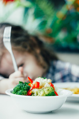 Kid in a restaurant and healthy food.