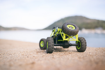 Radio-controlled car on the sand. Close up
