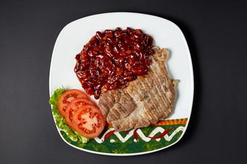 Pork steak with beans. Mexican food. Mexican cuisine.