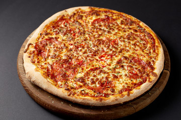 Hot pizza on a rustic wooden table.