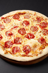Hot pizza Diablo on a rustic wooden table.