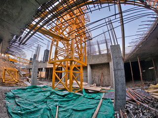 yellow crane in the core of the building