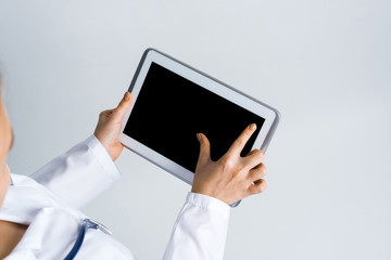 Close of female doctor hands working with tablet pc computer