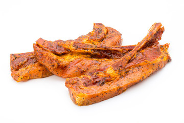 Spicy marinated spare ribs barbecued on the white background.