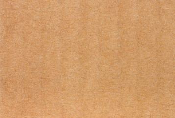 Close up of side view of a textured recycled packing cardboard with natural fiber parts