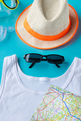 Travel kit: hat, googles, t-shirt, sun glasses. Flat lay composition for social media.
