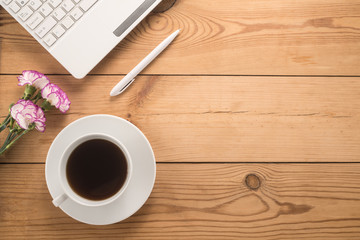  Office table with cup of coffee and flowers 