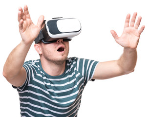 Naklejka premium Amazed man wearing virtual reality goggles watching movies or playing video games gesticulating hands, isolated on white background. Surprised male looking in VR glasses.